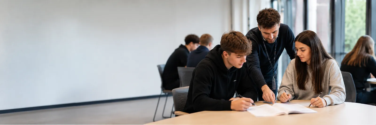 School leavers working through a programme workbook with a facilitator
